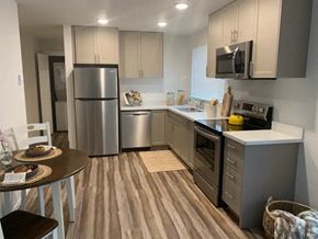 Tacoma apartment for rent - A kitchen with a refrigerator, oven, and microwave.