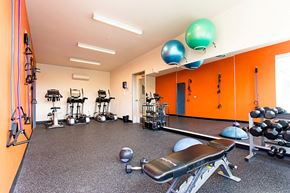 Portland apartment for rent - a gym with exercise equipment and balloons on the ceiling