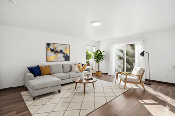 Lacey townhouse for rent - A living room with a grey couch and a painting on the wall.