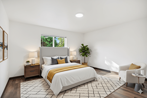 Lacey townhouse for rent - A bedroom with a large bed, a chair, and a potted plant.