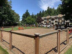 Kent apartment for rent - A playground with a wooden fence and a gravel ground.