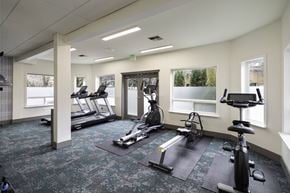 Seattle apartment for rent - a gym with exercise equipment and windows in a building