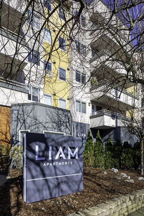 Seattle apartment for rent - an apartment building with a sign in front of it
