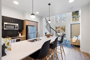 Seattle apartment for rent - an open kitchen and living room with a white counter top