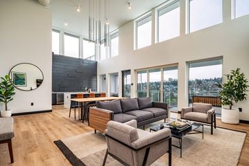 Seattle apartment for rent - a living room with couches and chairs and a table with a large window