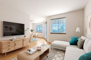 Vancouver apartment for rent - A living room with a television, a couch, and a coffee table.