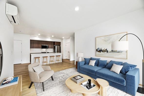 Arlington apartment for rent - A modern living room with a blue couch and a wooden coffee table.