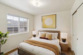 Bend apartment for rent - A bedroom with a large bed and a painting above it.