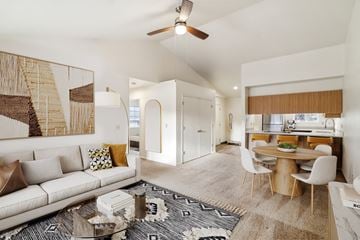 Bend apartment for rent - A living room with a white couch and a large painting on the wall.