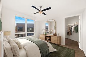 Seattle apartment for rent - A bedroom with a large bed and a ceiling fan.