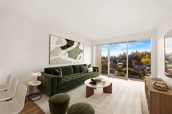 Seattle apartment for rent - A living room with a green couch, a coffee table, and a large painting on the wall.
