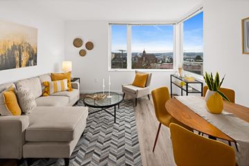 Seattle apartment for rent - a living room with a couch and a table and a window