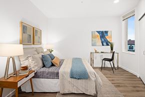 Seattle apartment for rent - a bedroom with a bed and a desk and a window