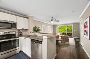 Bellevue townhouse for rent - A kitchen with white cabinets and a stainless steel dishwasher.