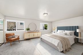 Bothell apartment for rent - A bedroom with a bed, chair, and window.