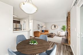 Bothell apartment for rent - A modern dining room with a wooden table and blue chairs.