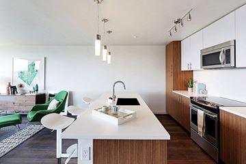 Seattle apartment for rent - a kitchen and living room with a table and a sink