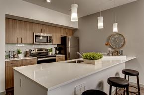 Sammamish apartment for rent - a kitchen with a large counter top and a clock