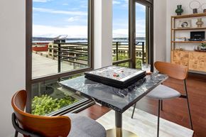 Seattle apartment for rent - a dining room with a glass table and a view of the ocean
