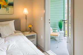 Kirkland apartment for rent - a bedroom with a bed and a door to a patio