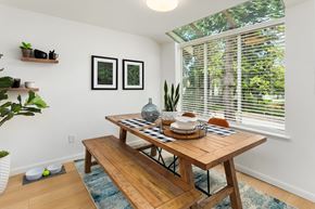 Federal Way apartment for rent - a dining room with a wooden table and a large window