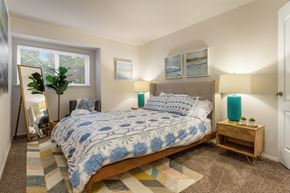 Kent apartment for rent - a bedroom with a bed and a mirror and a window
