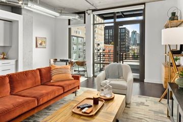 Seattle apartment for rent - a living room with a couch and a chair and a sliding glass door