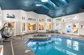 Burien apartment for rent - A large indoor swimming pool with a sunken seating area.