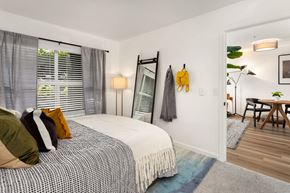 Seattle apartment for rent - a bedroom with a bed and a mirror on the wall