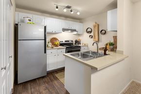 Kent apartment for rent - a kitchen with stainless steel appliances and white cabinets