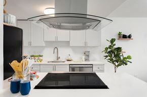 Federal Way apartment for rent - a white kitchen with a black stove and a white counter top