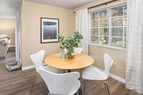 Lynnwood apartment for rent - a dining room with a table and chairs and a window