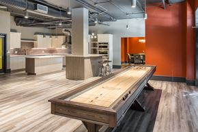Kirkland apartment for rent - a shuffleboard table in a room with a kitchen