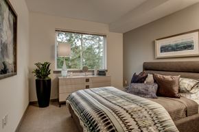 Sammamish apartment for rent - a bedroom with a bed and a dresser and a window