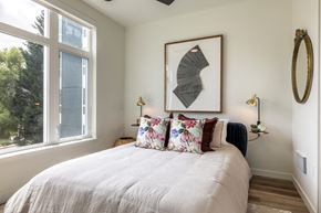Seattle apartment for rent - a bedroom with a bed and a large window