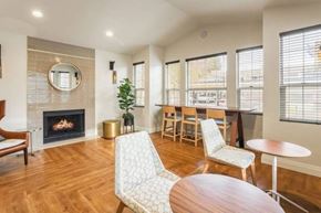 Seattle apartment for rent - A living room with a fireplace and a chair.