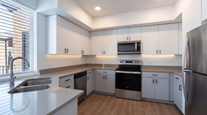 Bend apartment for rent - A modern kitchen with stainless steel appliances and white cabinets.
