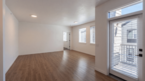 Bend apartment for rent - A room with wooden floors and white walls.