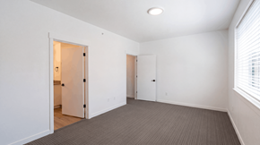 Bend apartment for rent - A room with carpeted flooring and two doors.
