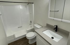 Monroe apartment for rent - A white toilet sits next to a sink in a small bathroom.