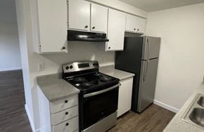 Monroe apartment for rent - A kitchen with black appliances and white cabinets.