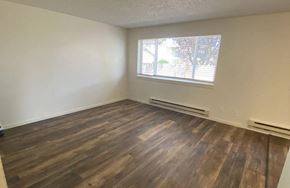 Monroe apartment for rent - A room with wooden flooring and a window with blinds.