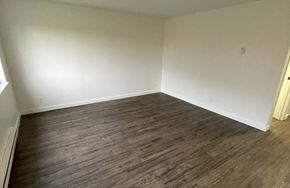 Monroe apartment for rent - A room with wooden flooring and white walls.
