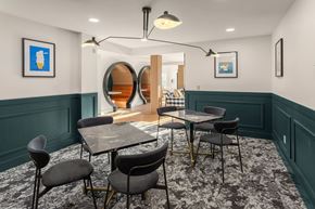 Seattle apartment for rent - a dining room with tables and chairs and green walls