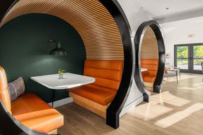 Seattle apartment for rent - a meeting room with orange chairs and a white table