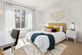 Kirkland apartment for rent - a bedroom with a bed and a large window