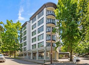 Seattle apartment for rent - a building on the corner of a street with trees