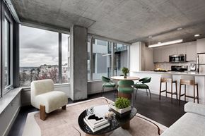 Seattle apartment for rent - A modern living room with a large window overlooking a snowy landscape.