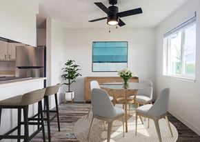 Tacoma apartment for rent - A dining room with a table set for two and a ceiling fan.
