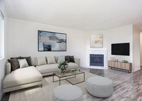 Tacoma apartment for rent - A living room with a white couch, a coffee table, and a fireplace.